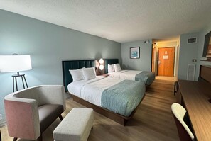 A hotel room with two beds, a desk, a chair, a lamp, and a picture on the wall. - Wingate by Wyndham Indianapolis East (Indianapolis)