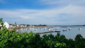 A harbor with boats, a church, and a bridge in the background.