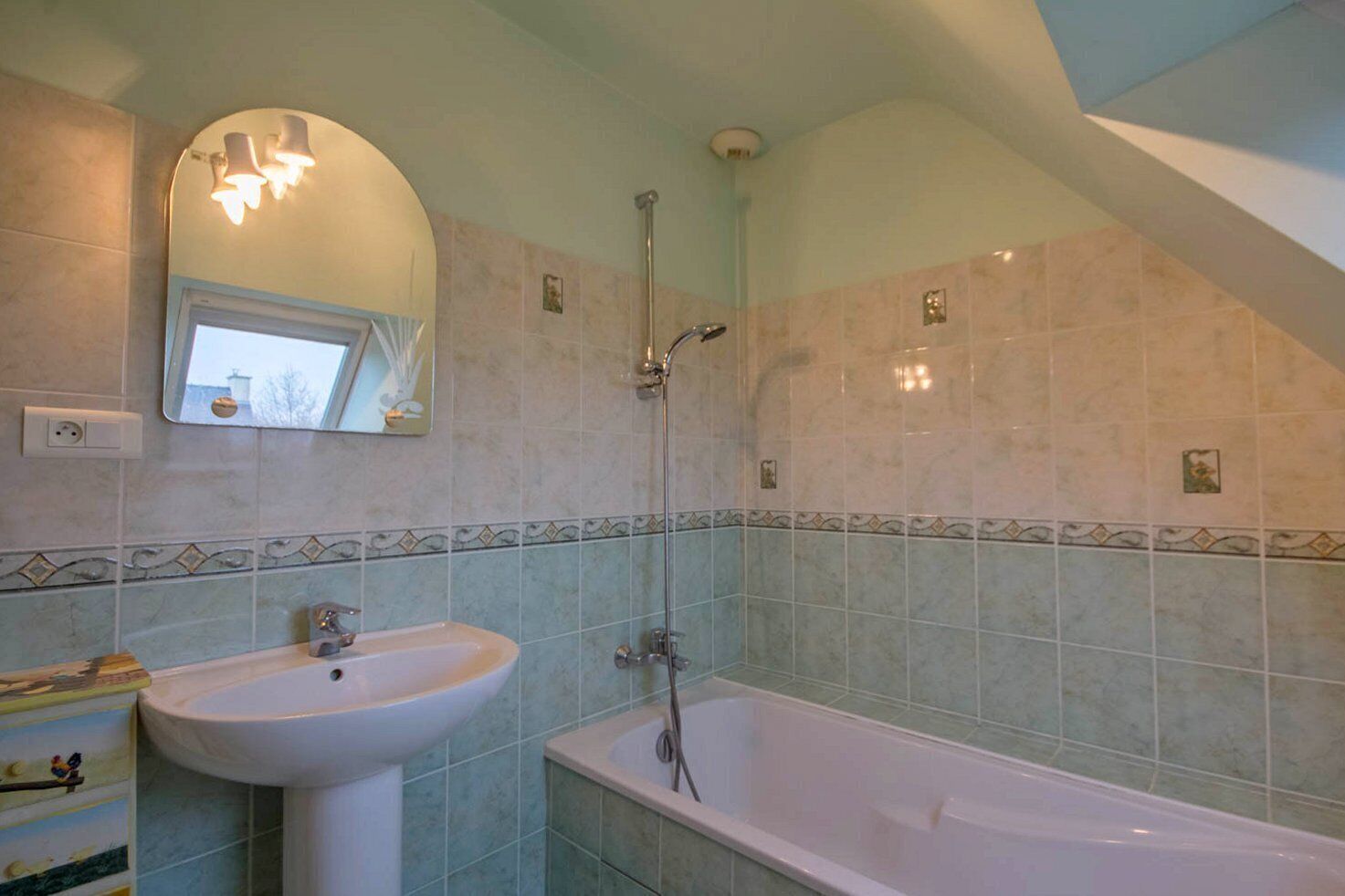 A bathroom with a sink, bathtub, and shower.