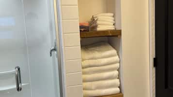 Shower, towels, soap, toilet paper