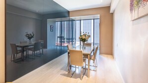 A modern interior with a dining area, large windows, and a glass partition. - Moderno Departamento En Reforma 284 (Mexico City)
