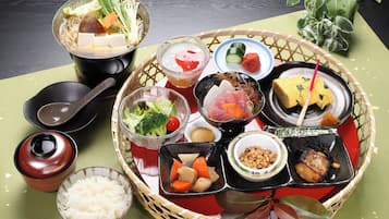 A traditional Japanese meal with various dishes and side items on a table.