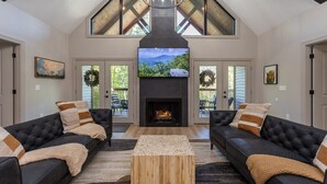 A modern living room with a fireplace, two sofas, and a coffee table.