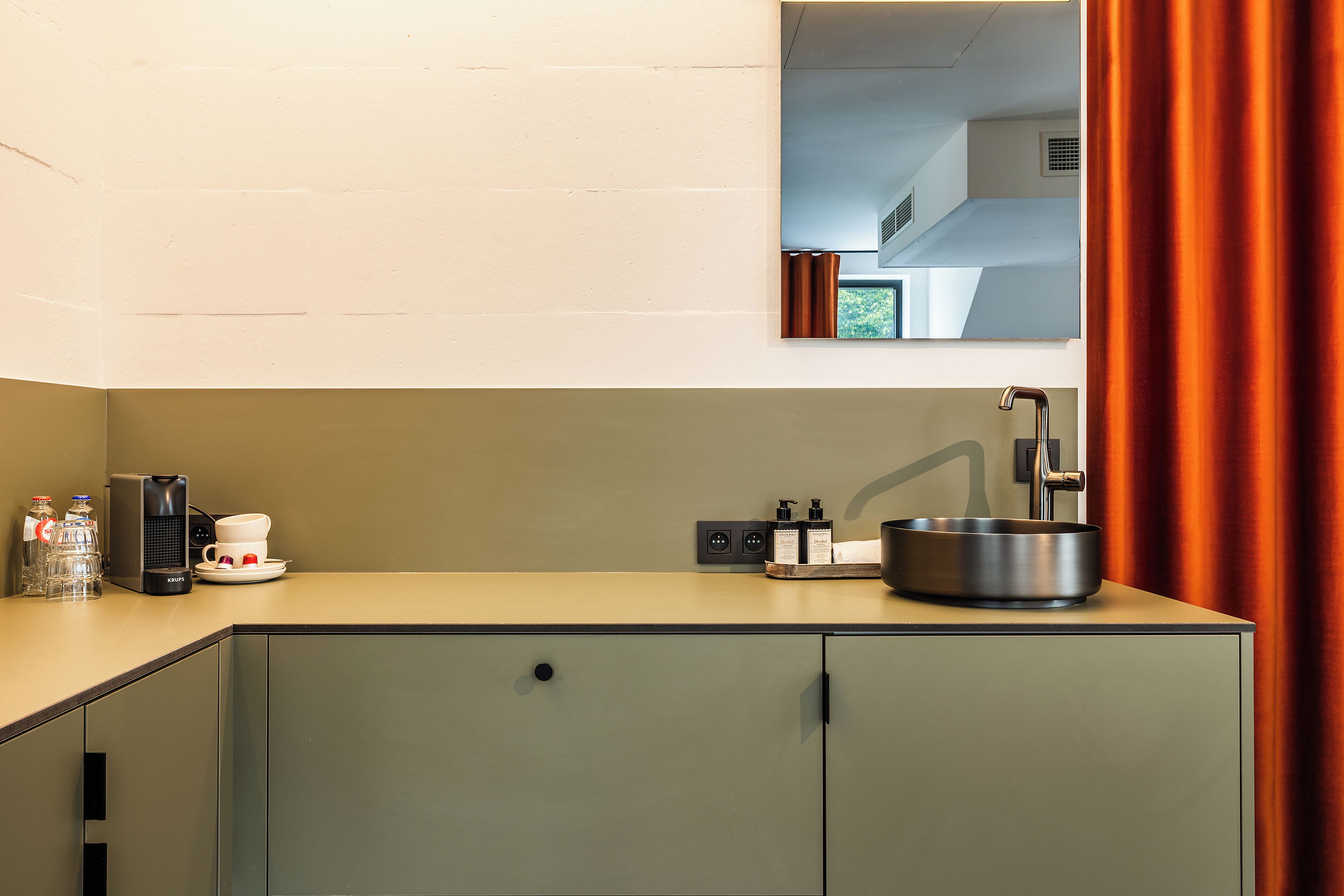 A modern bathroom with a sink, mirror, and cabinets.