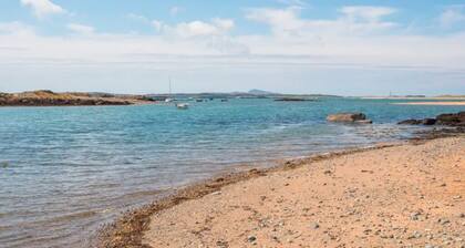 This recently renovated coastal oasis combines contemporary comfort with beach-chic style