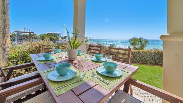 An outdoor dining area with a table set for four, overlooking a beach and ocean view. - ENDLESS VIEWS, Gulf-Front, Pool, Grill, Lg Patio, 30A, Great Location (Santa Rosa)