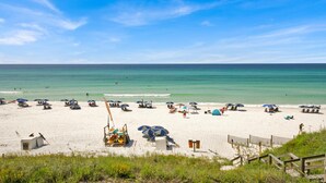 A beach with white sand, clear blue water, and a wooden fence in the foreground. - ENDLESS VIEWS, Gulf-Front, Pool, Grill, Lg Patio, 30A, Great Location (Santa Rosa)
