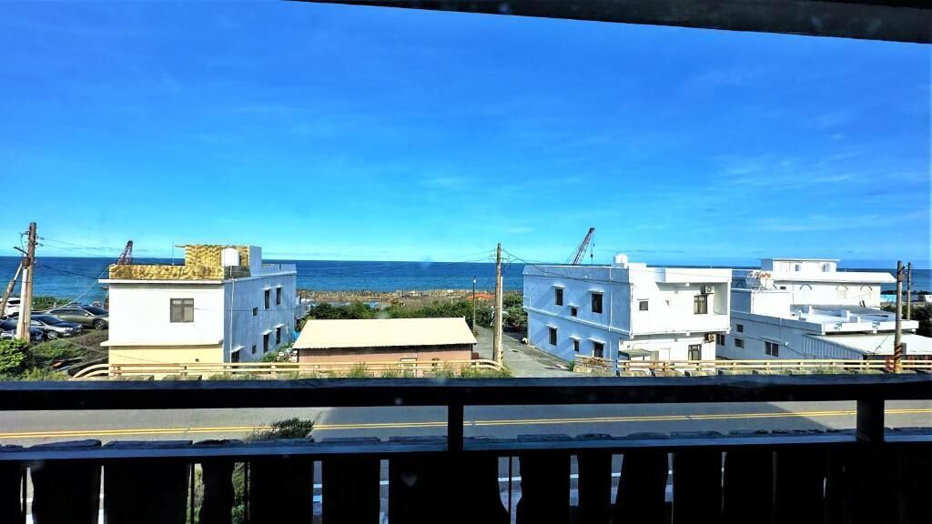 A coastal view with buildings and a clear sky.