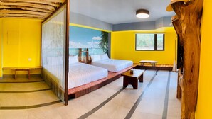 A room with two beds, a bench, a small table, and a mural of a beach scene. - Kenting Singhaiwan (Hengchun)