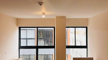 Exclusive Apartment | Living area | 60-inch flat-screen TV with satellite channels, heated floors