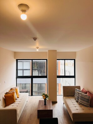 Exclusive Apartment | Living area | 60-inch flat-screen TV with satellite channels, heated floors