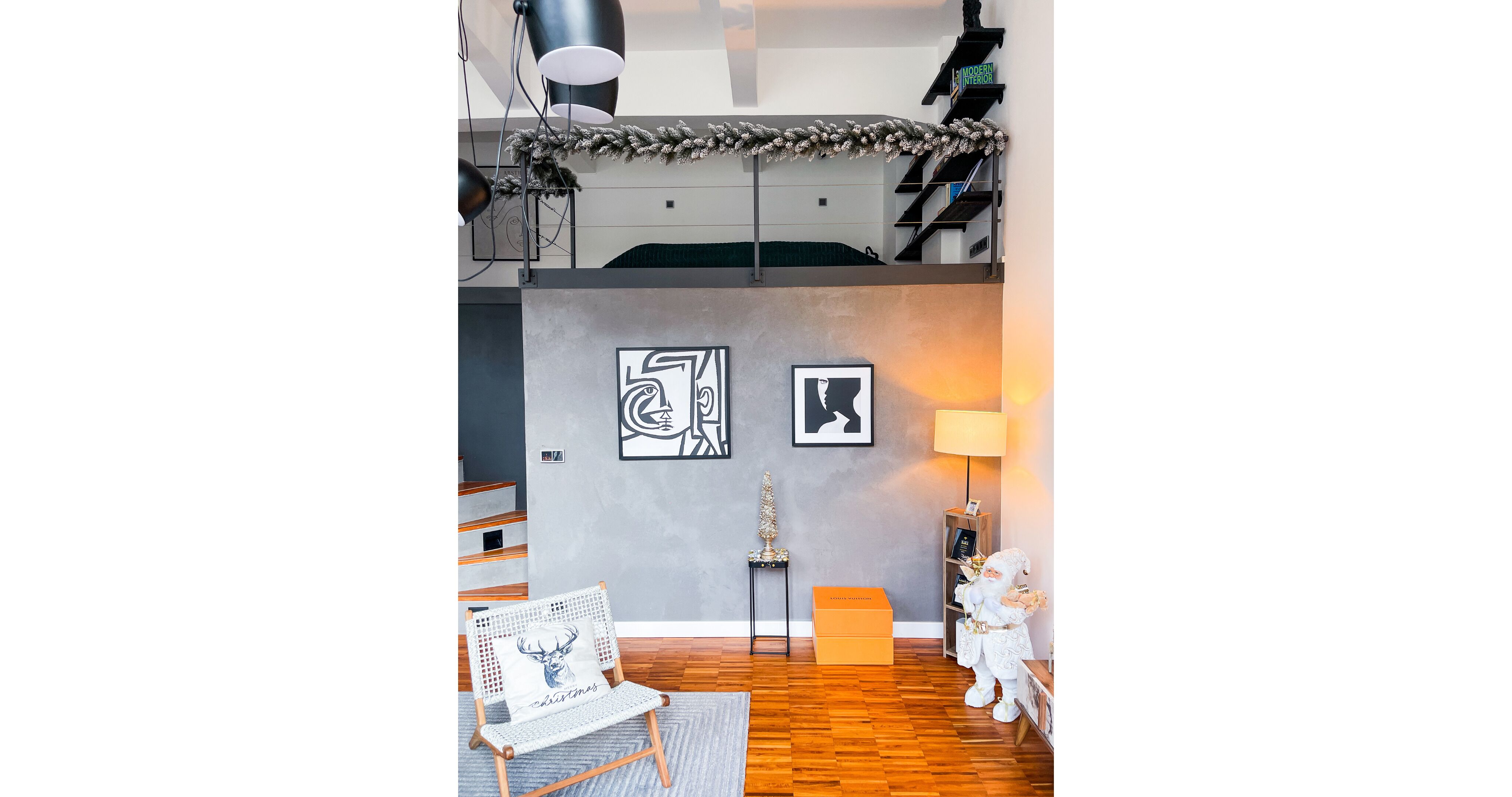Un dormitorio tipo loft moderno con cama en altura, una escalera y una decoración minimalista.