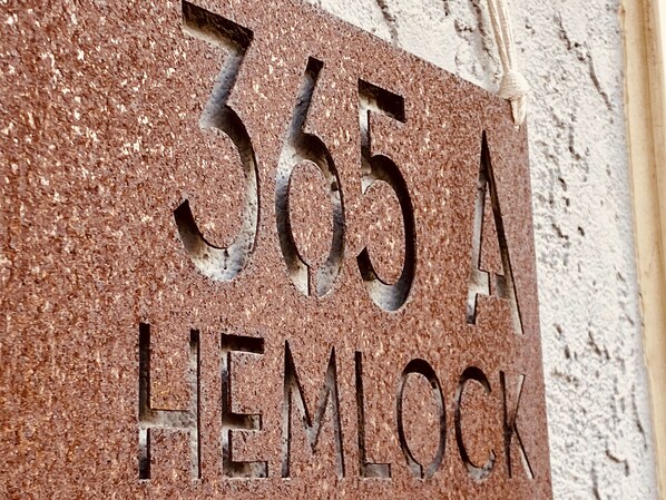A stone sign with the number "365 A" and the word "HEMLOCK" carved into it.