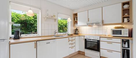 Fridge, stovetop, dishwasher, coffee/tea maker