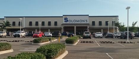 A parking lot in front of a building with a sign that reads "Solomon's."