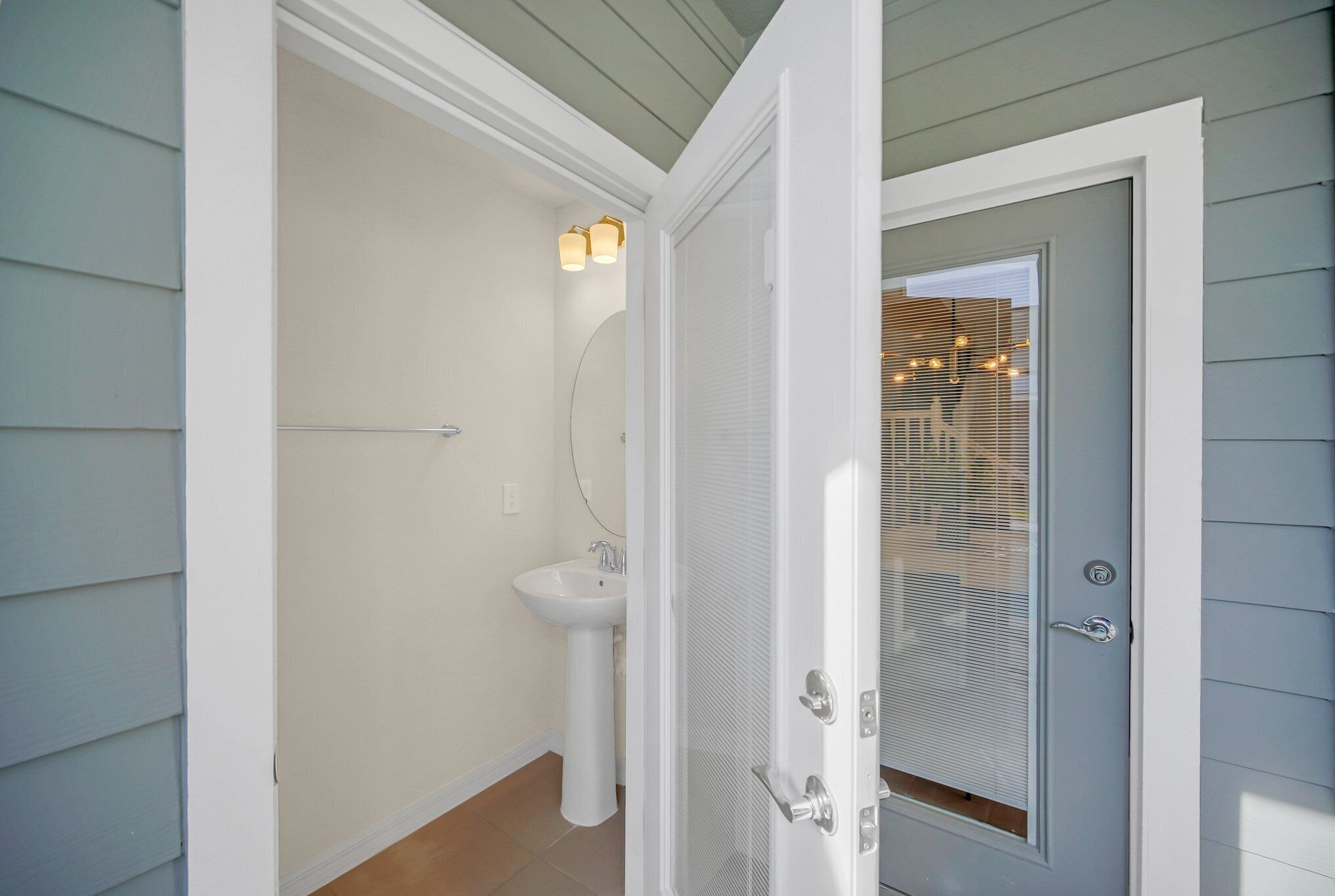 A bathroom with a white sink, a toilet, and a shower door.