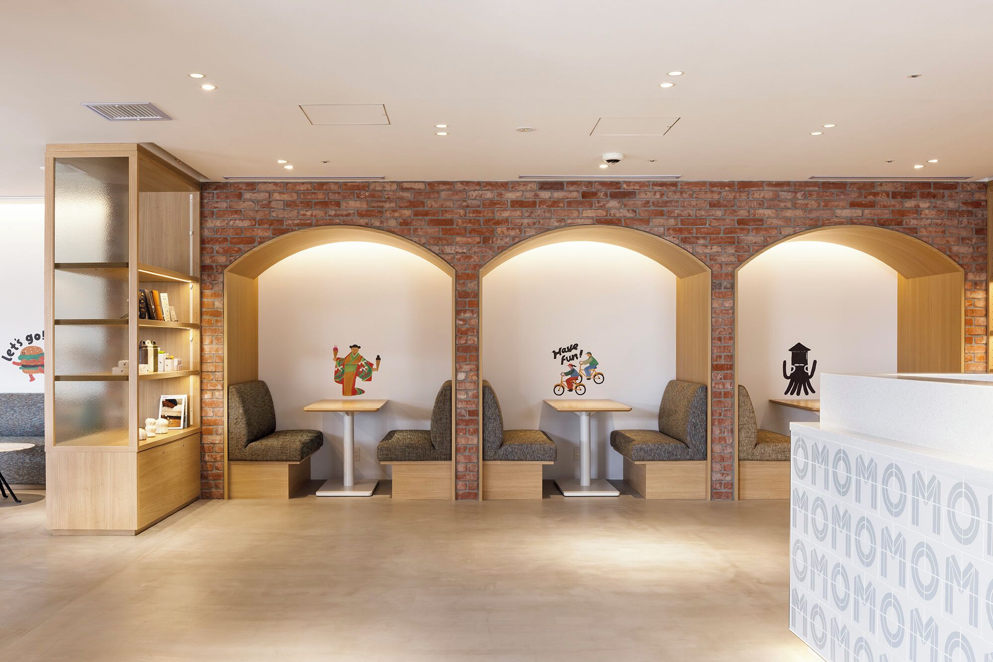 A reception area with a brick wall, arched alcoves, and a reception desk.