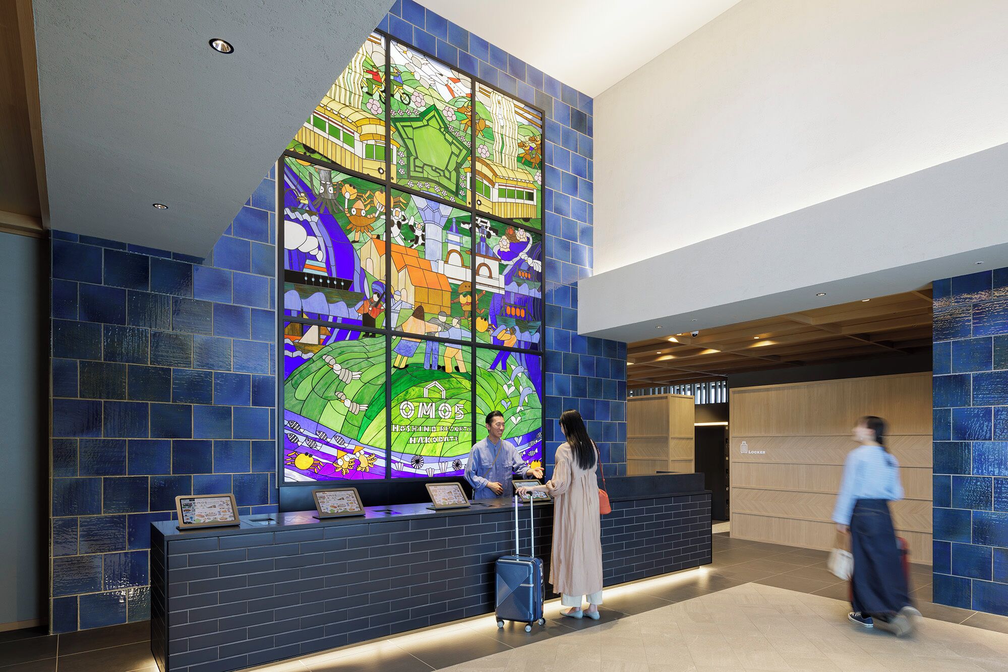 Un'area reception con un'ampia finestra a vetri colorati, una scrivania e un banco per il check-in.