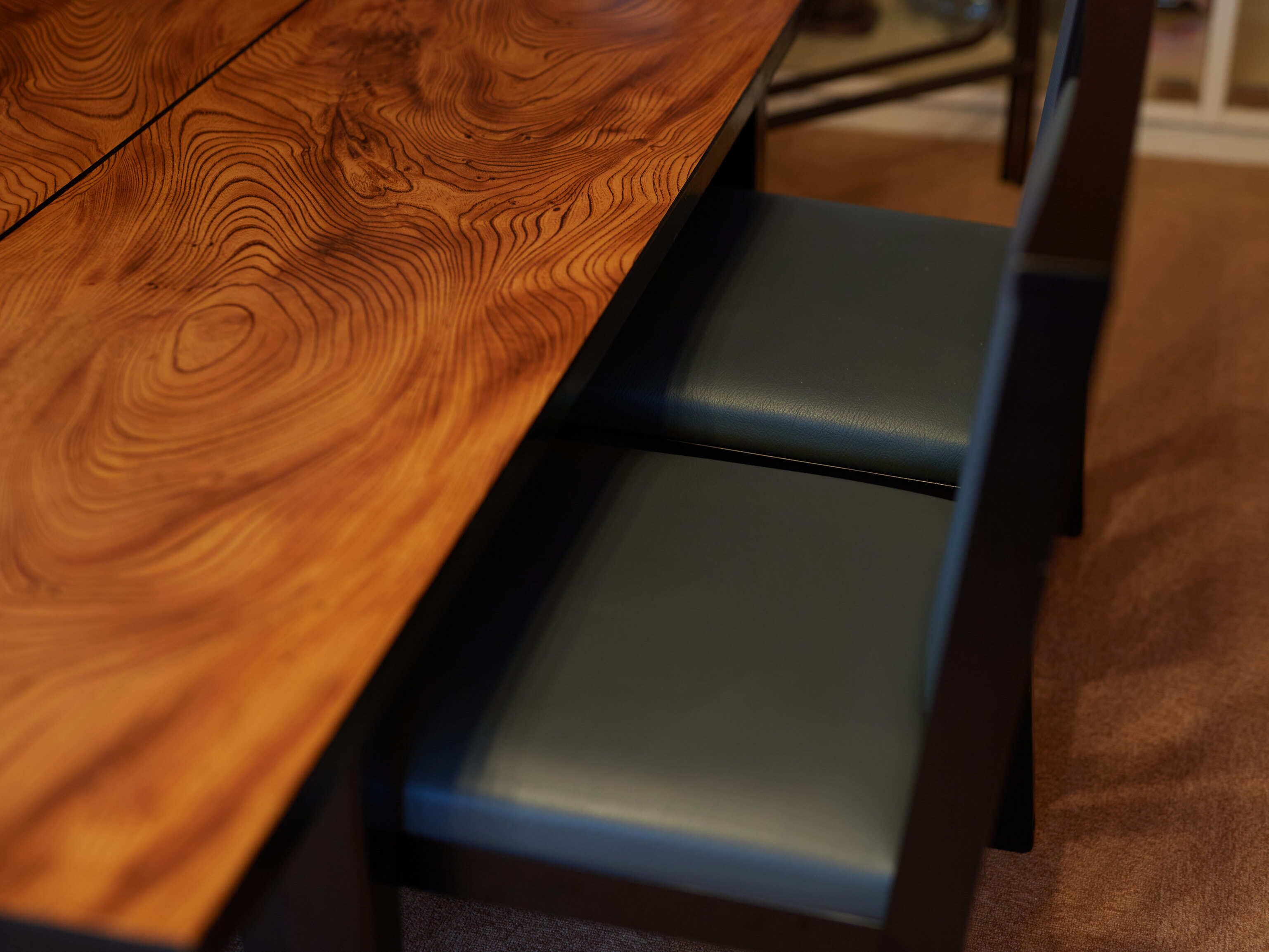 Una mesa de madera con un banco oscuro.