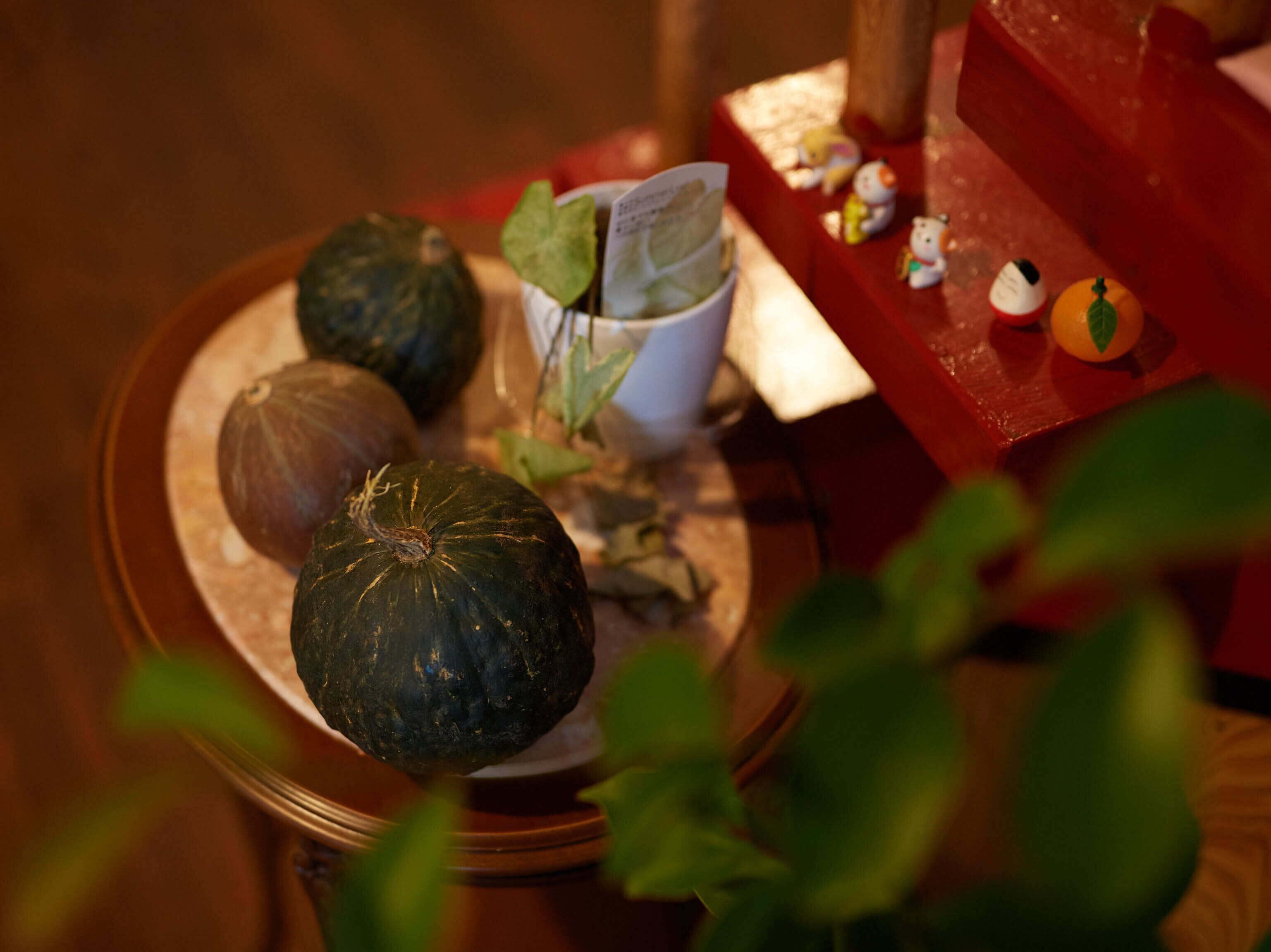 A table with pumpkins and a white cup.