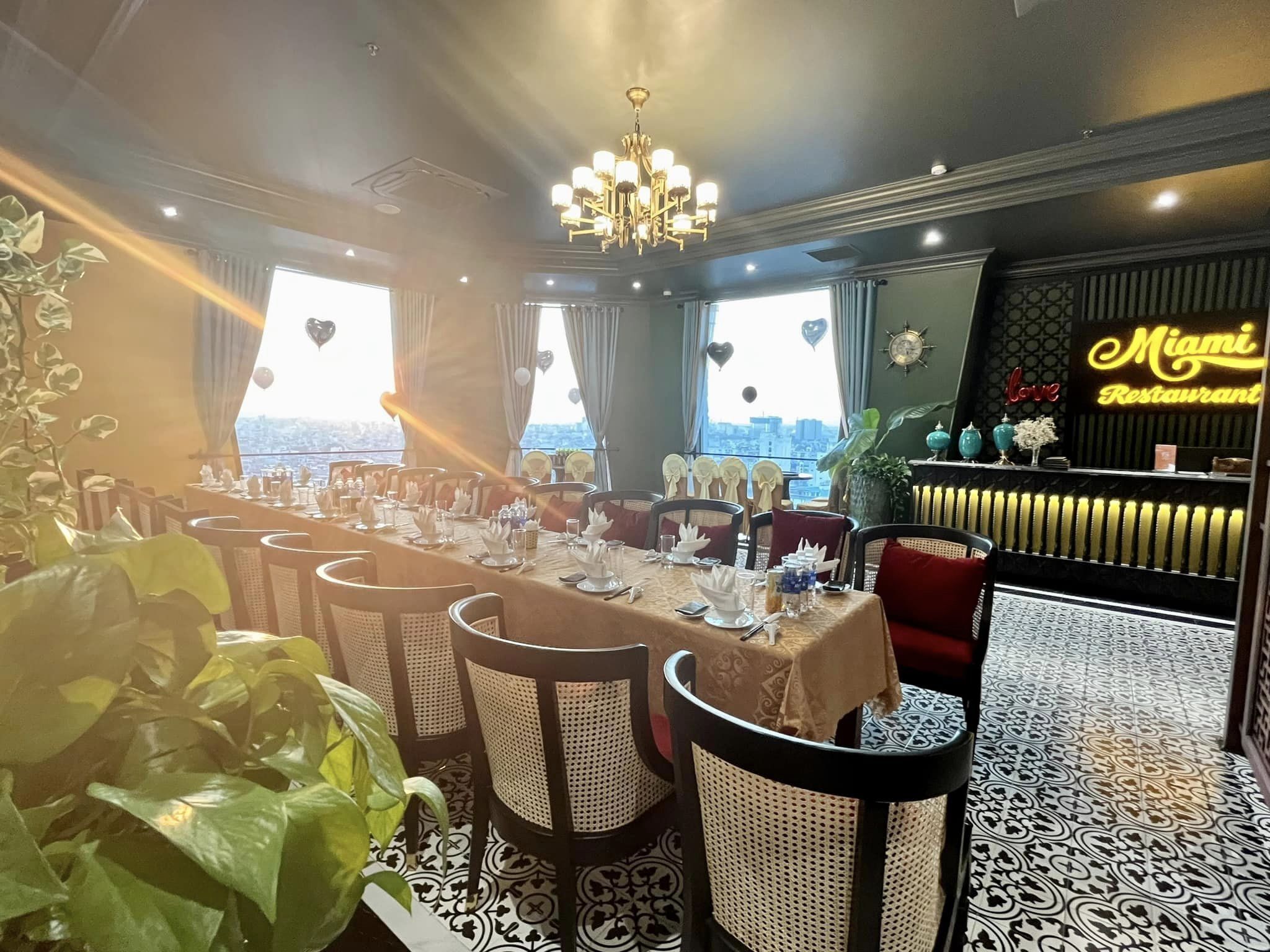 A restaurant with a long dining table set for multiple guests, surrounded by chairs.