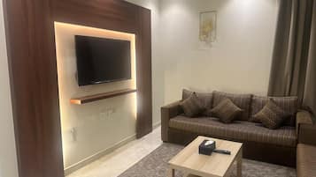 Deluxe Double Room | Living area | 40-cm flat-screen TV with satellite channels