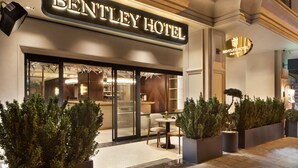 The exterior of the Bentley Hotel with a prominent sign, a reception area visible through the glass doors, and well-maintained landscaping with potted plants. - Bentley Hotel Old City - Special Class (Istanbul)