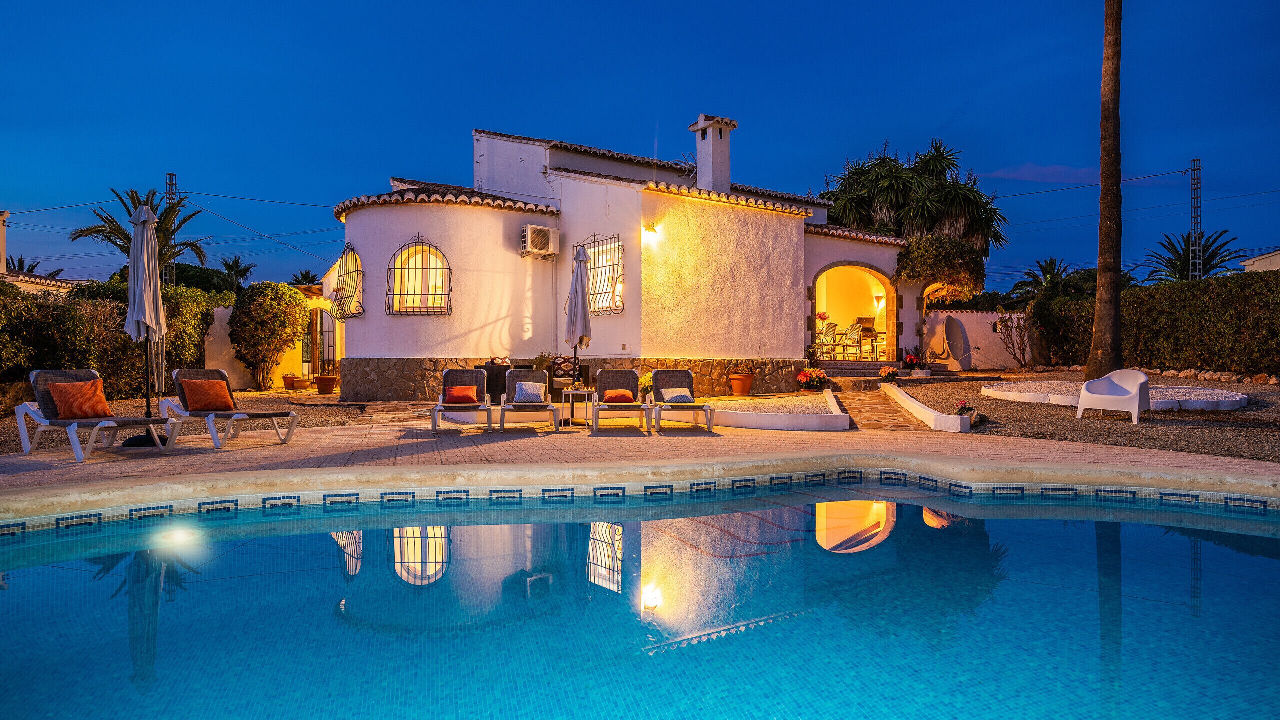 A poolside area with lounge chairs and a swimming pool.