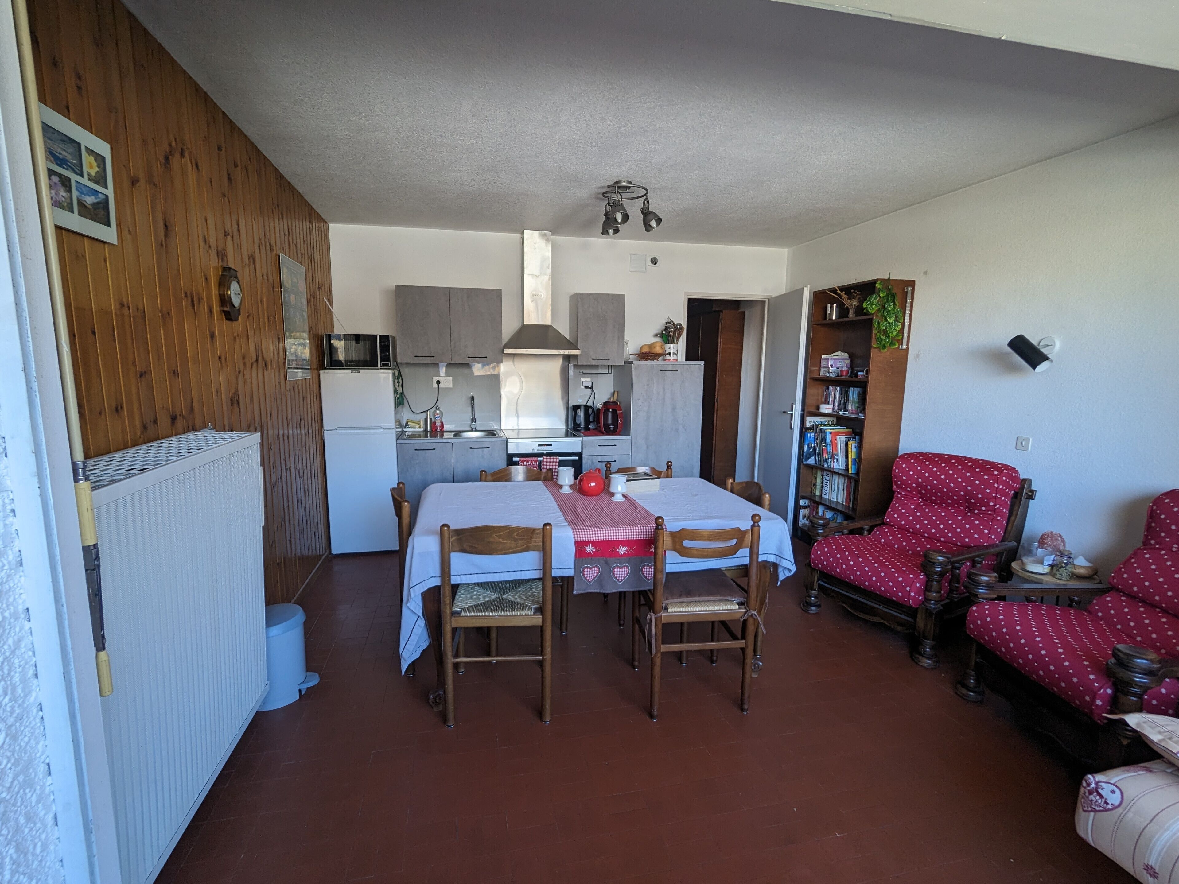 A compact living space with a kitchen, dining area, and seating area.