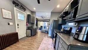 A modern kitchen with granite countertops, stainless steel appliances, and a central island. - Convenient 1 BR close southside (Pittsburgh)