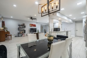 A modern kitchen with a refrigerator, microwave, and sink.