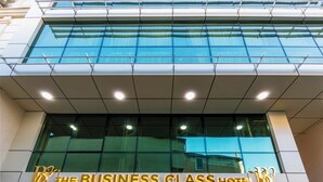 The exterior of The Business Class Hotel with a modern glass facade and illuminated signage. - The Business Class Hotel (Istanbul)