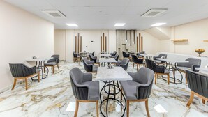 A conference room with marble flooring, black and white checkered chairs, and a long table. - The Business Class Hotel (Istanbul)