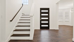 A staircase leading to a black door with a window above it. - Austin UrbanScape, 5min to Kalahari water park! (Round Rock)