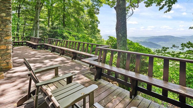 A wooden deck with benches and a railing overlooking a forested area with distant mountains. - Blue Ridge Mountain VIEWS | Pet Friendly | Near Boone & Blowing Rock (Boone)