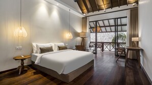A modern hotel room with a large bed, two bedside lamps, a wooden floor, and a balcony with a view. - Nusantara Loft Alor by Alfred in Bali (Canggu)