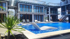 Outdoor pool, open 9:00 AM to 9:00 PM, pool loungers