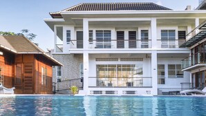 A two-story building with a swimming pool in front. - SMARANALA  (Nusa Dua)