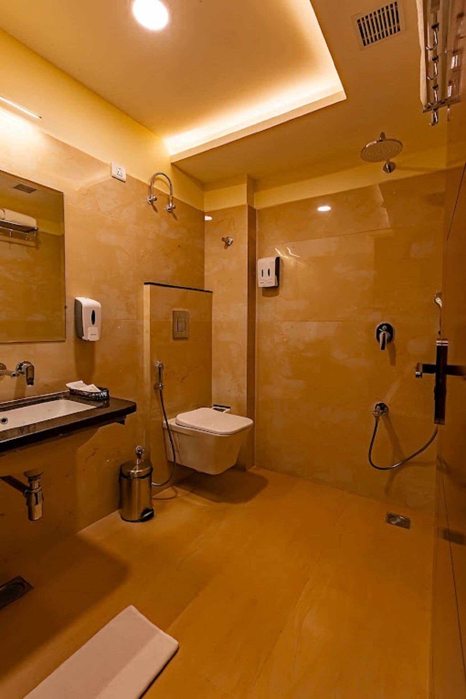 A modern bathroom with a sink, mirror, and shower area.