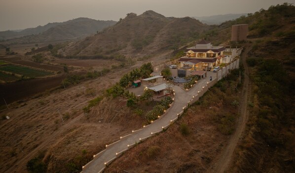 Situated on a hillside, this two-story building offers a serene setting surrounded by a landscaped garden and rolling hills.