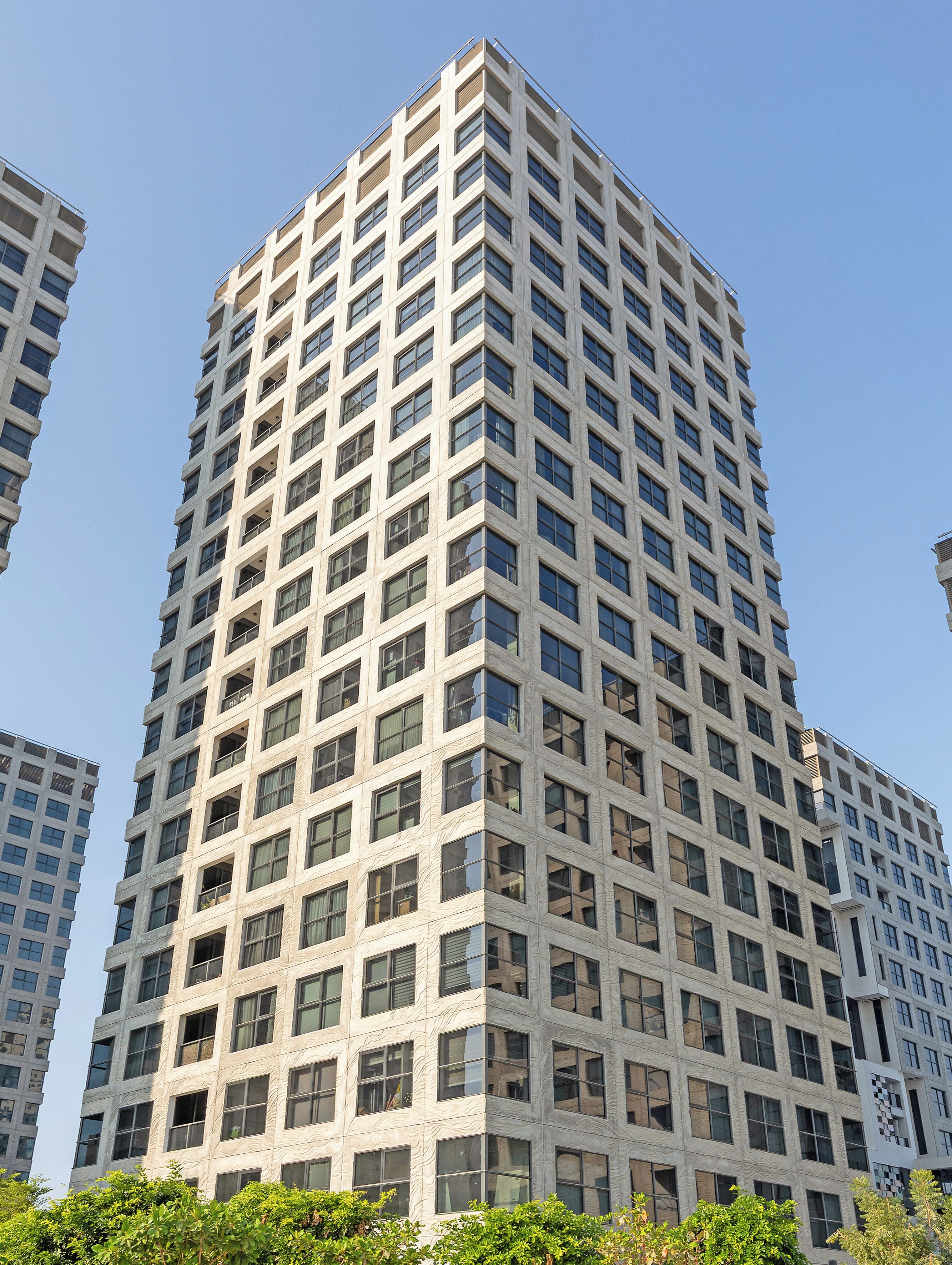A high-rise building with a grid of windows and balconies.