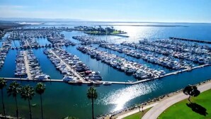 An aerial view of a marina with numerous boats docked in a structured layout.