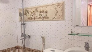 A bathroom with a toilet, shower, and sink. - Tran Bui-242 Phan Xich Long-by BayLuxury (Ho Chi Minh City)