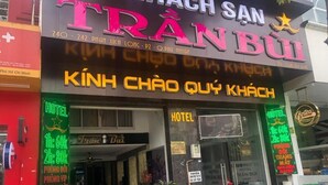A hotel entrance with neon signs indicating room rates and amenities. - Tran Bui-242 Phan Xich Long-by BayLuxury (Ho Chi Minh City)