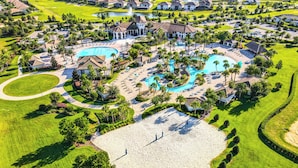 A golf course with a large pool area, multiple buildings, and well-maintained landscaping.