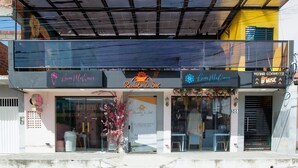 Un bâtiment dont la façade comprend une vitrine sur laquelle est apposée une enseigne indiquant : « Recanto do Sol ».