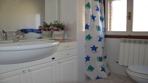 A bathroom with a white sink, a mirror, a window with a view, and a shower curtain with a star pattern. - Relaxing Villa Near the sea in Caorle (Caorle)