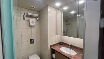 A modern bathroom with a toilet, sink, and mirror.