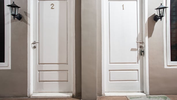 Two white doors with numbers 1 and 2, each with a keyhole and a door handle. - Hotel O Almahyra Guest House Syariah (Jambi)