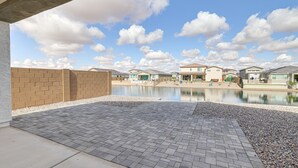 A courtyard with a water feature, brick walls, and modern buildings in the background. - Spacious Maricopa Vacation Home ~ 4 Mi to Downtown (Maricopa)